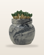 Round cement match holder in black and white marble, filled with matches