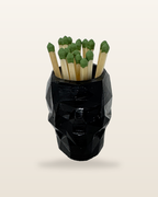 Skull cement match holder in black gloss, filled with matches