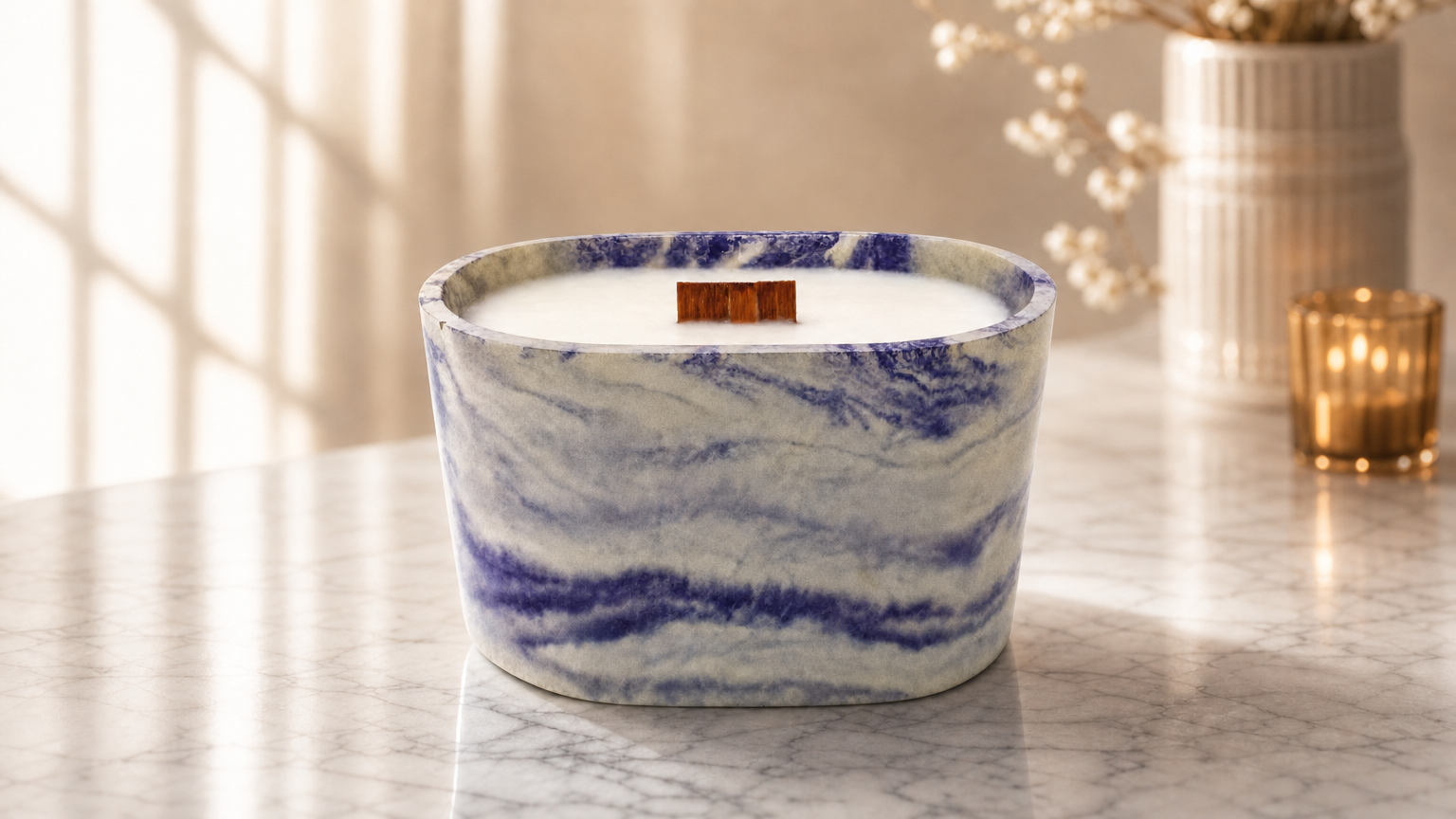 A purple marbled candle on a table with flowers
