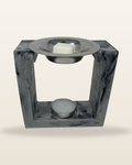 Square cement wax melter in grey and black marble with a tealight and wax melt